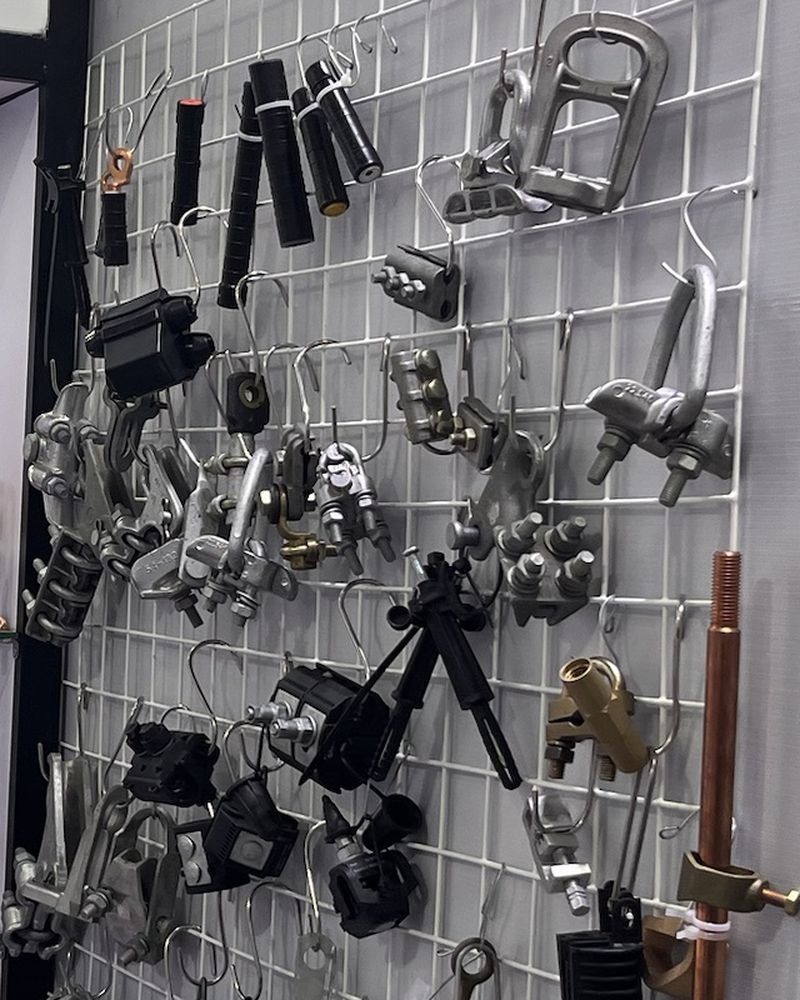Overhead line fittings and clamps hung on a display grid